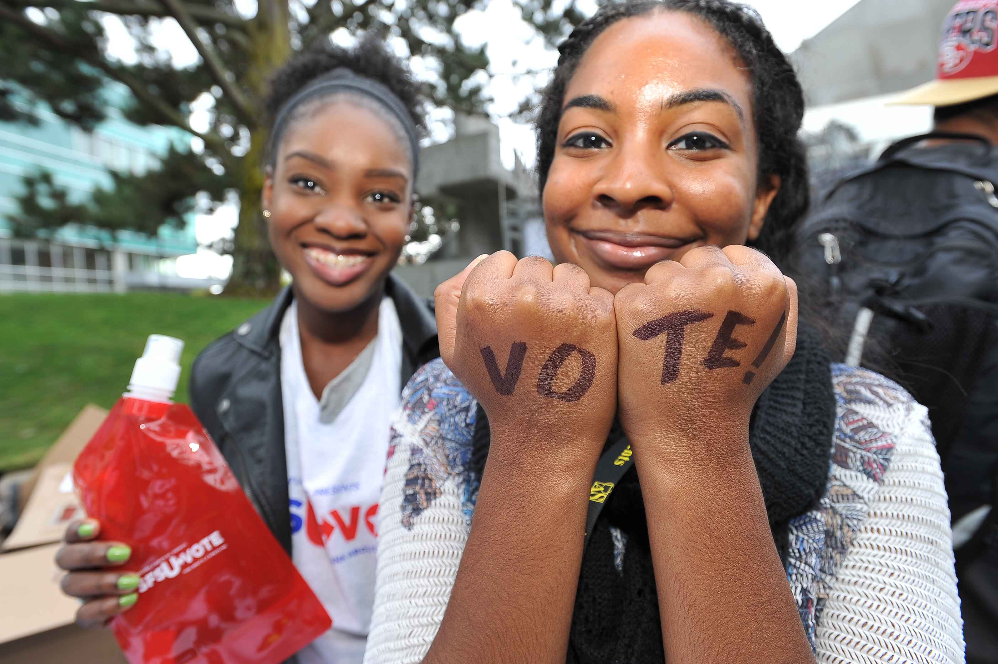 Student with Vote written on hands